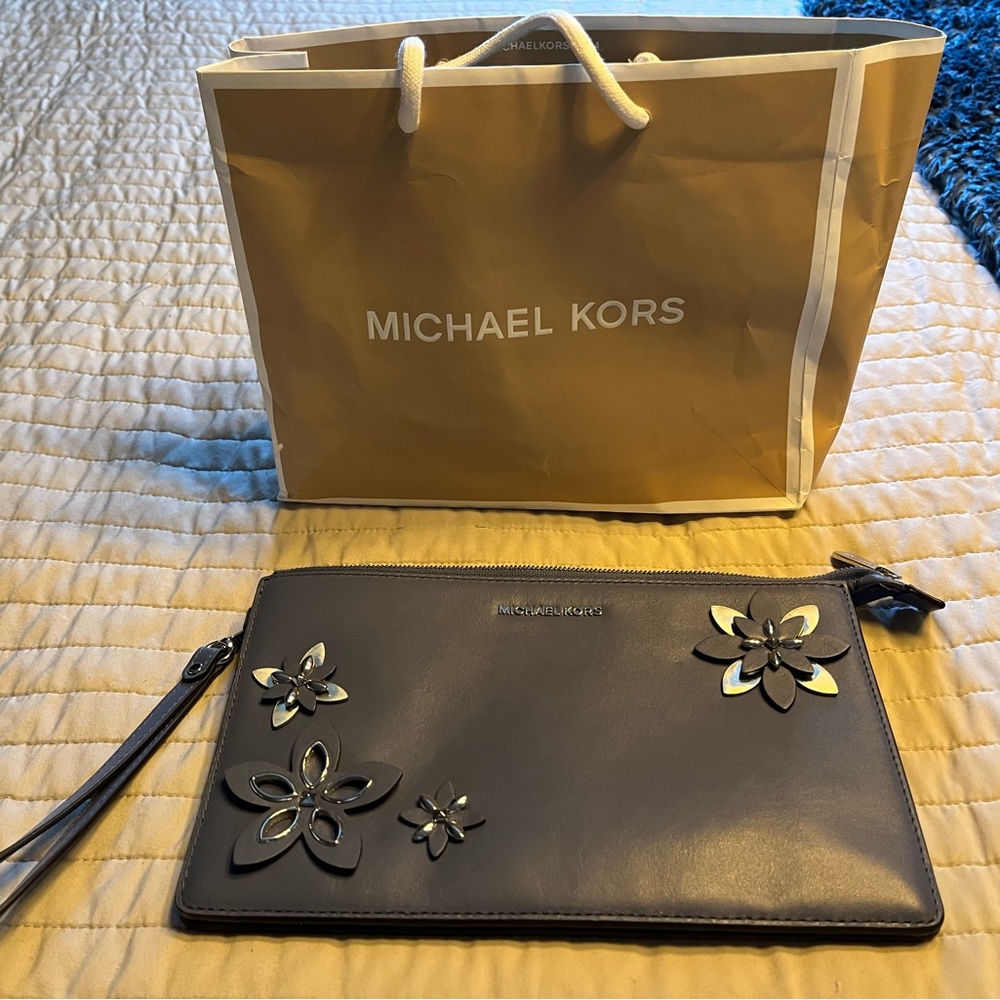 Authentic Michael lots clutch never used. Blue grey in color.
